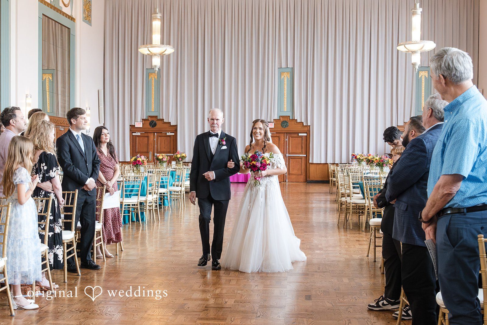 The bride's father escorts the bride down the aisle