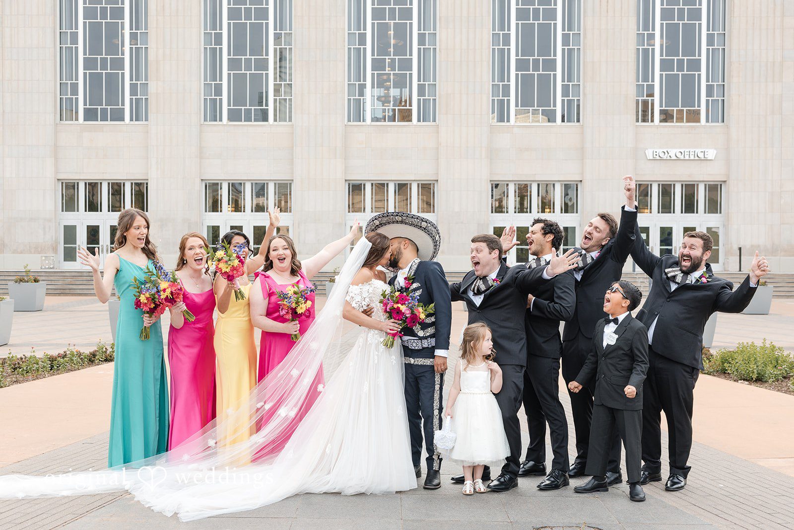 A romantic portrait of the couple with cheers from their bridal party
