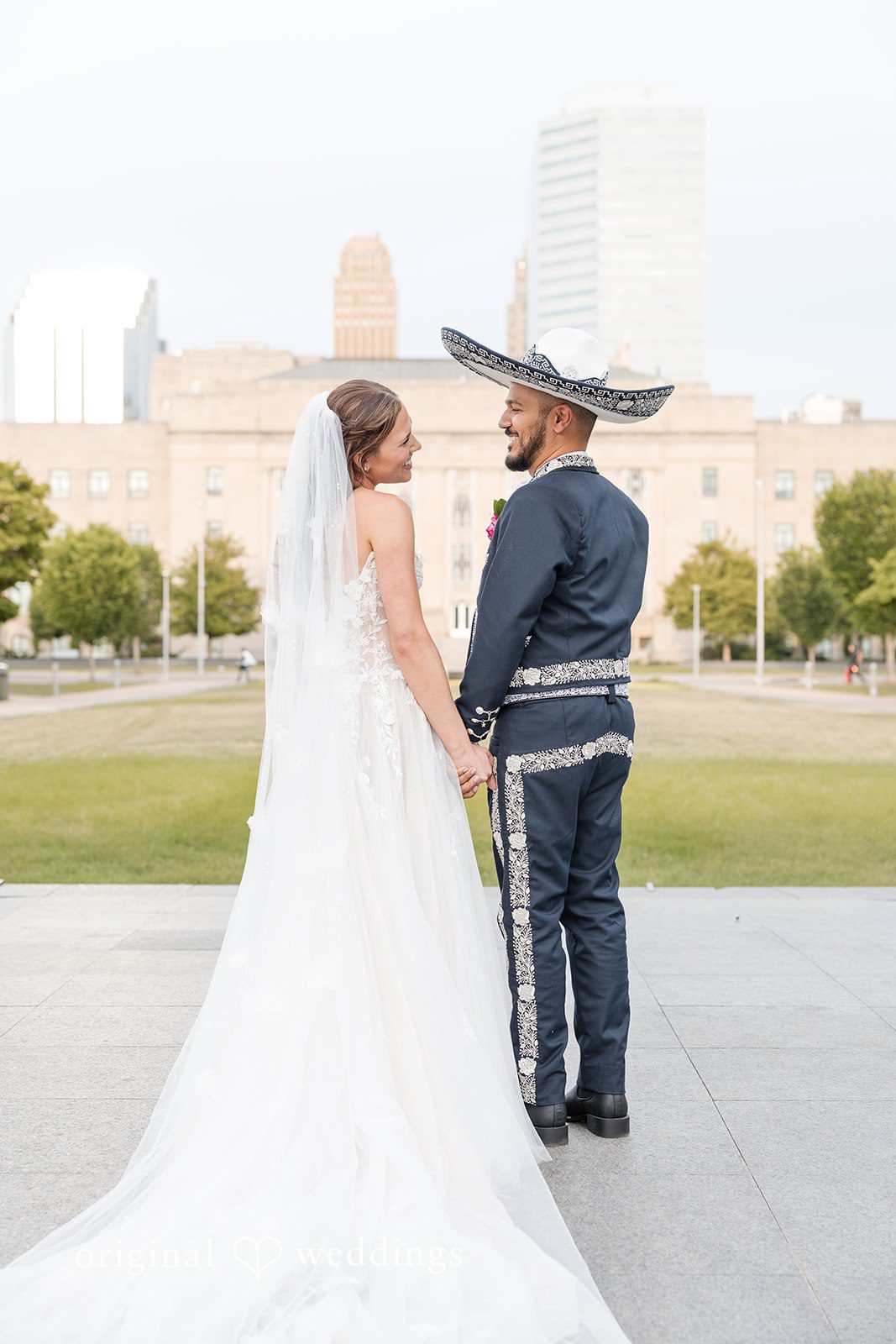 A back-view portrait of the couple at the Meinders Hall of Mirrors environs