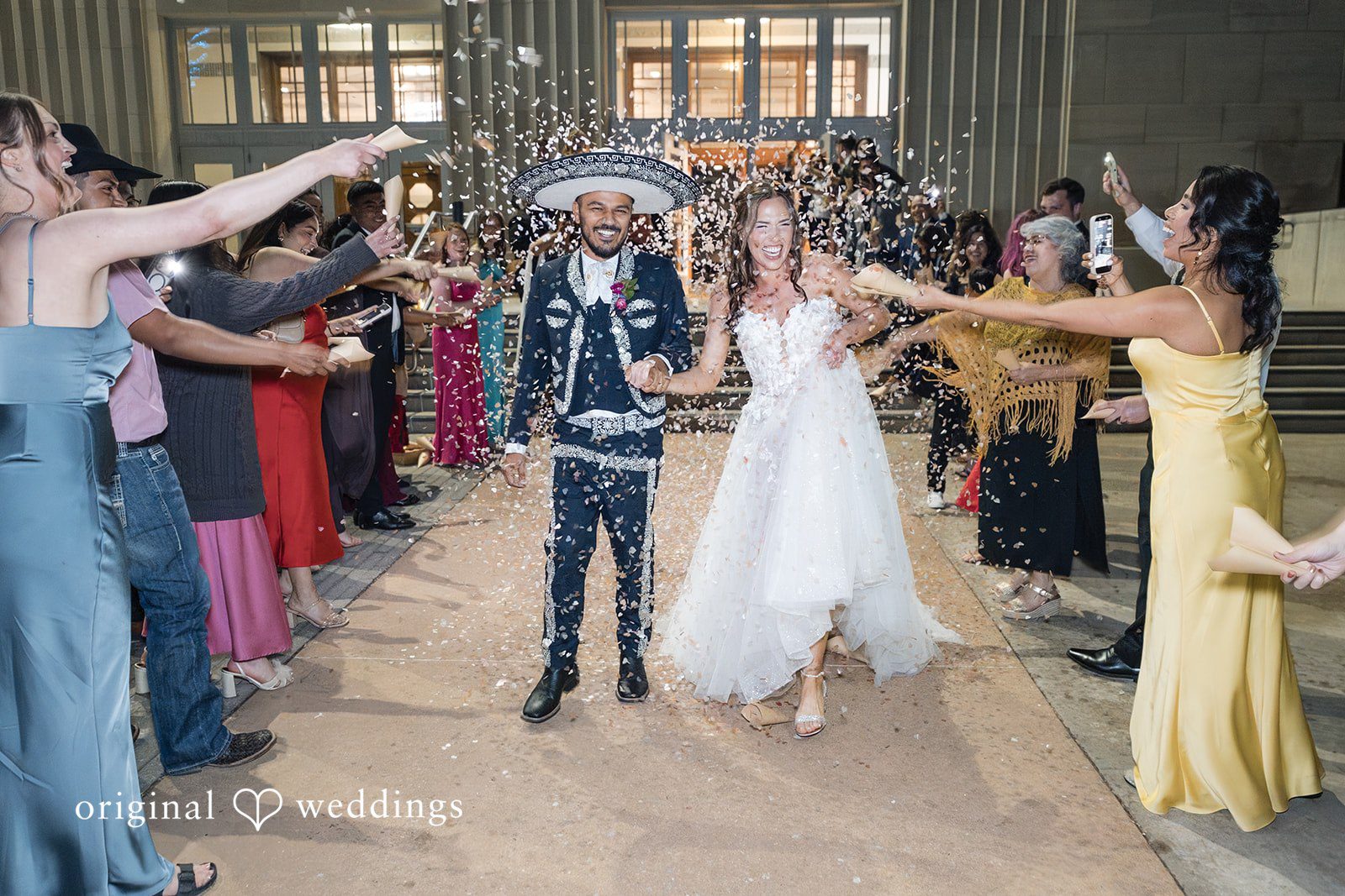 The couple makes a joyful exit with cheers from their wedding party