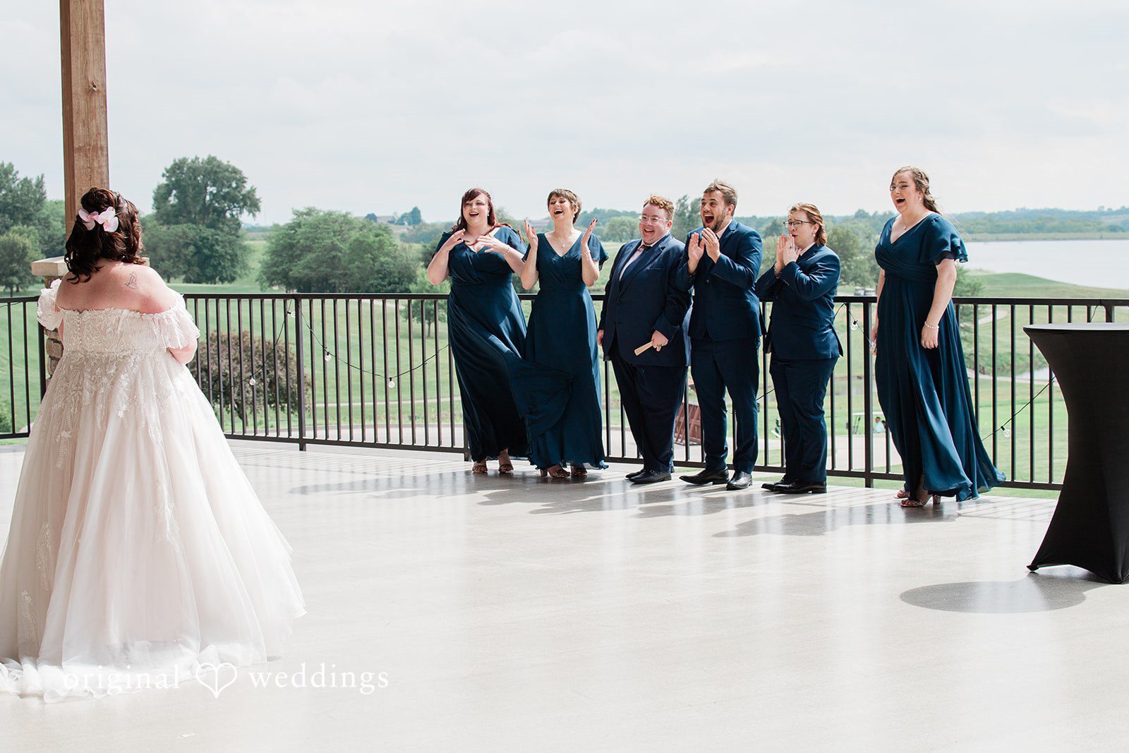 The bride unveils herself to her bridesmaids
