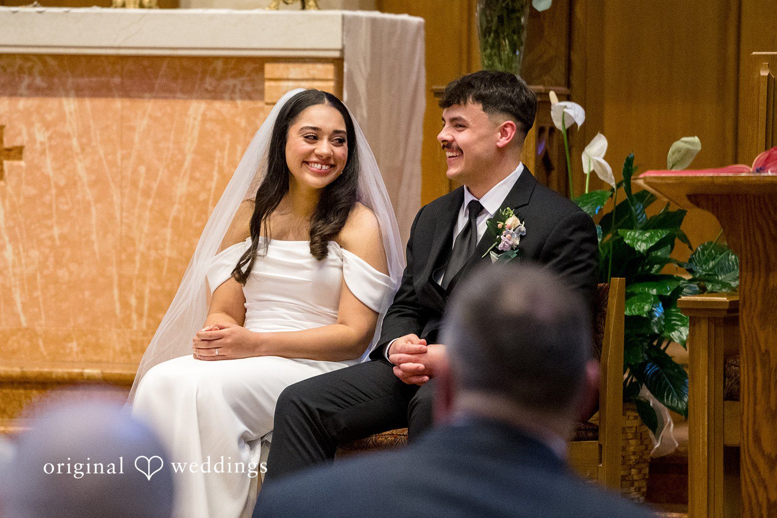 Kiarra + Anthony Romantic couple sitting wedding pose at Nativity of Our Lord Catholic Church