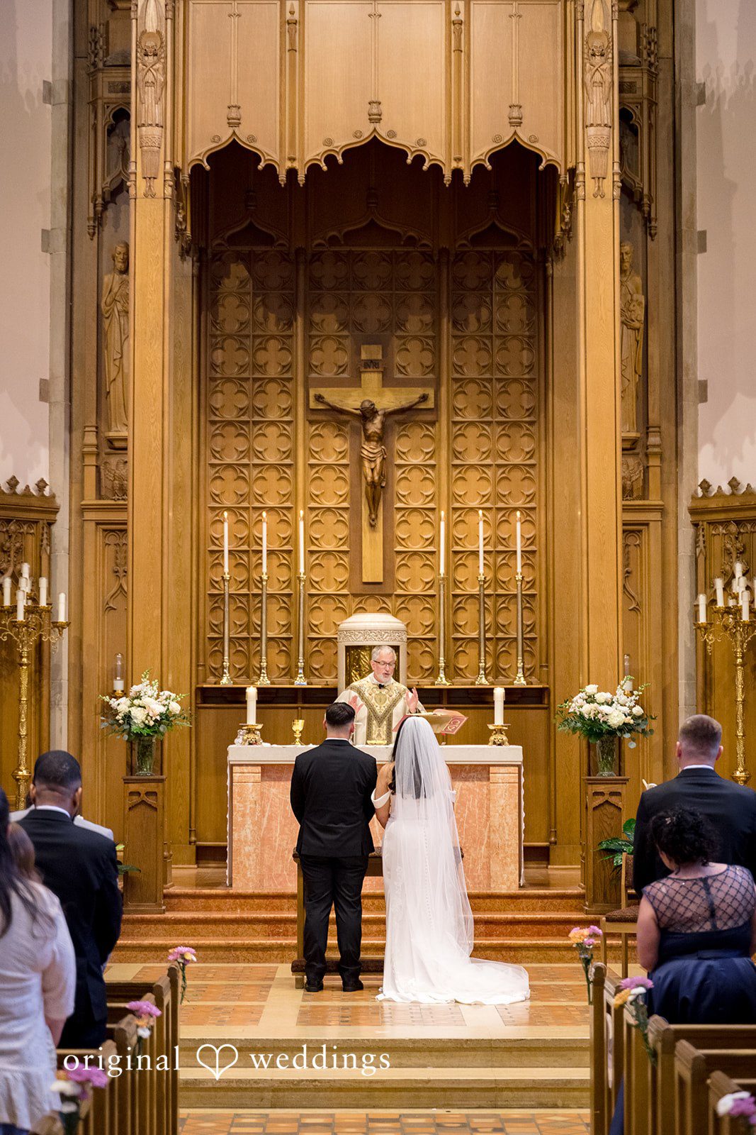 Kiarra + Anthony Romantic couple back pose ceremony shot at Nativity of Our Lord Catholic Church