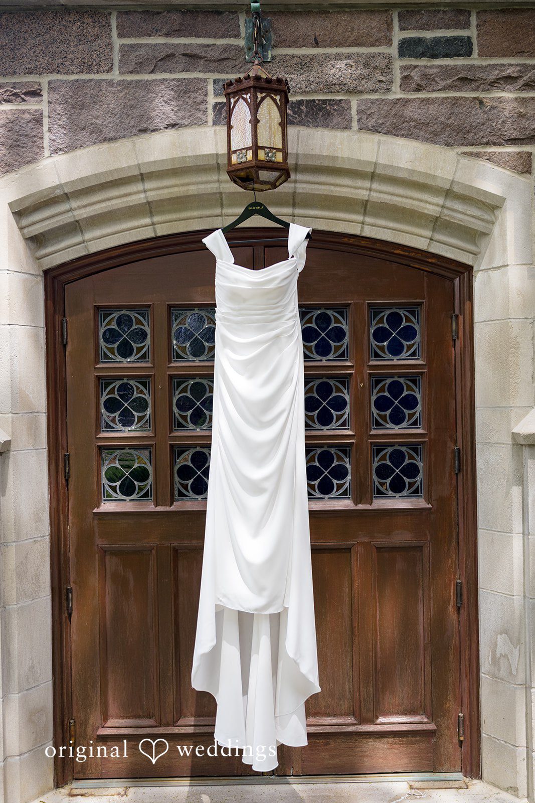 Kiarra + Anthony Stylish bridal dress hanging shot at Nativity of Our Lord Catholic Church