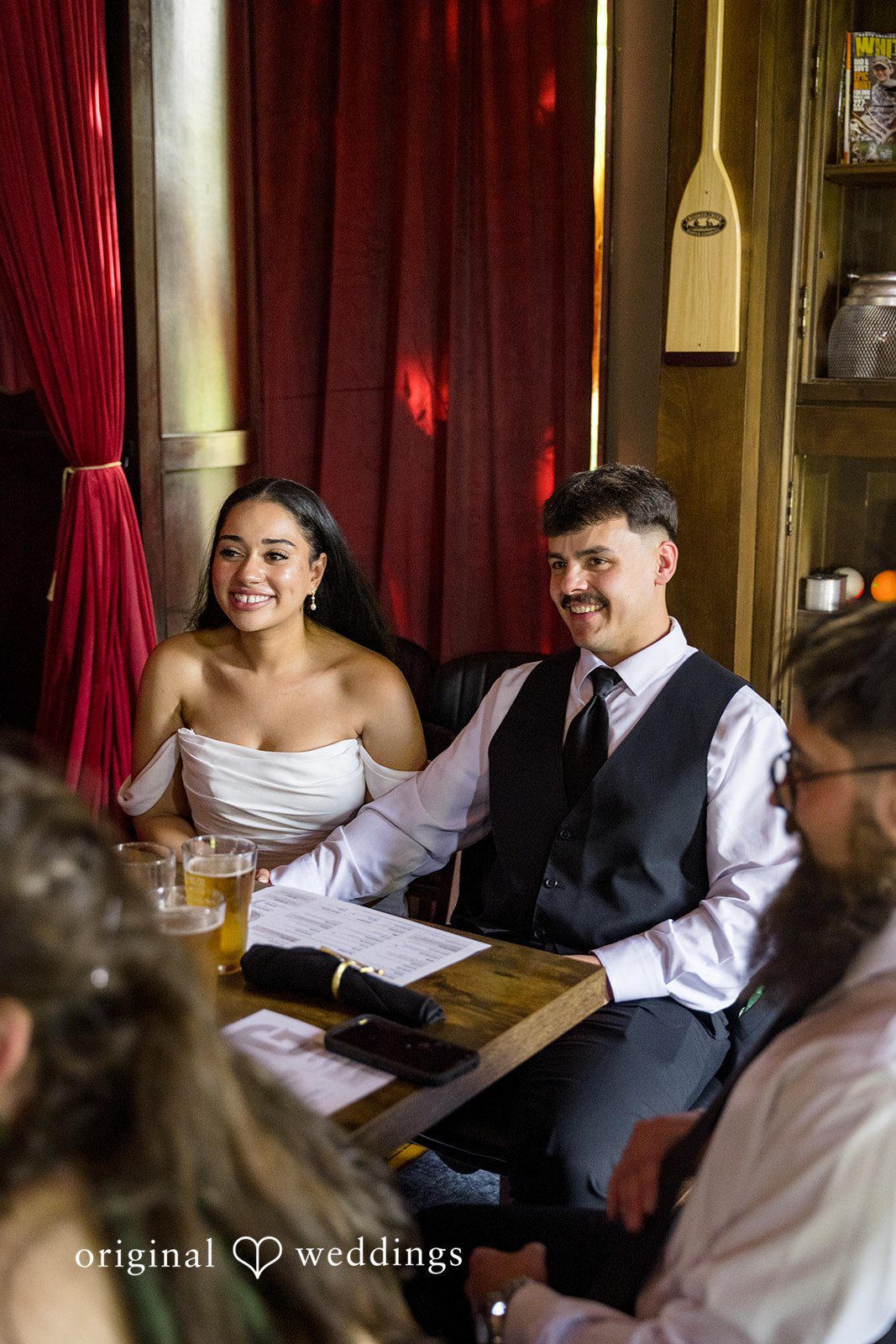Kiarra + Anthony Minneapolis Wedding Photographers capturing the couple sitting together at Nativity of Our Lord Catholic Church by Original Weddings.