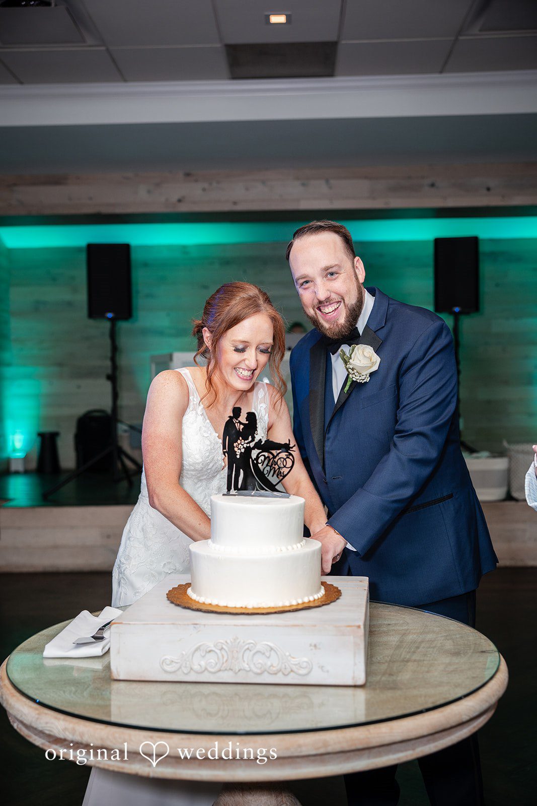 Bride and groom cutting their wedding cake during the celebration