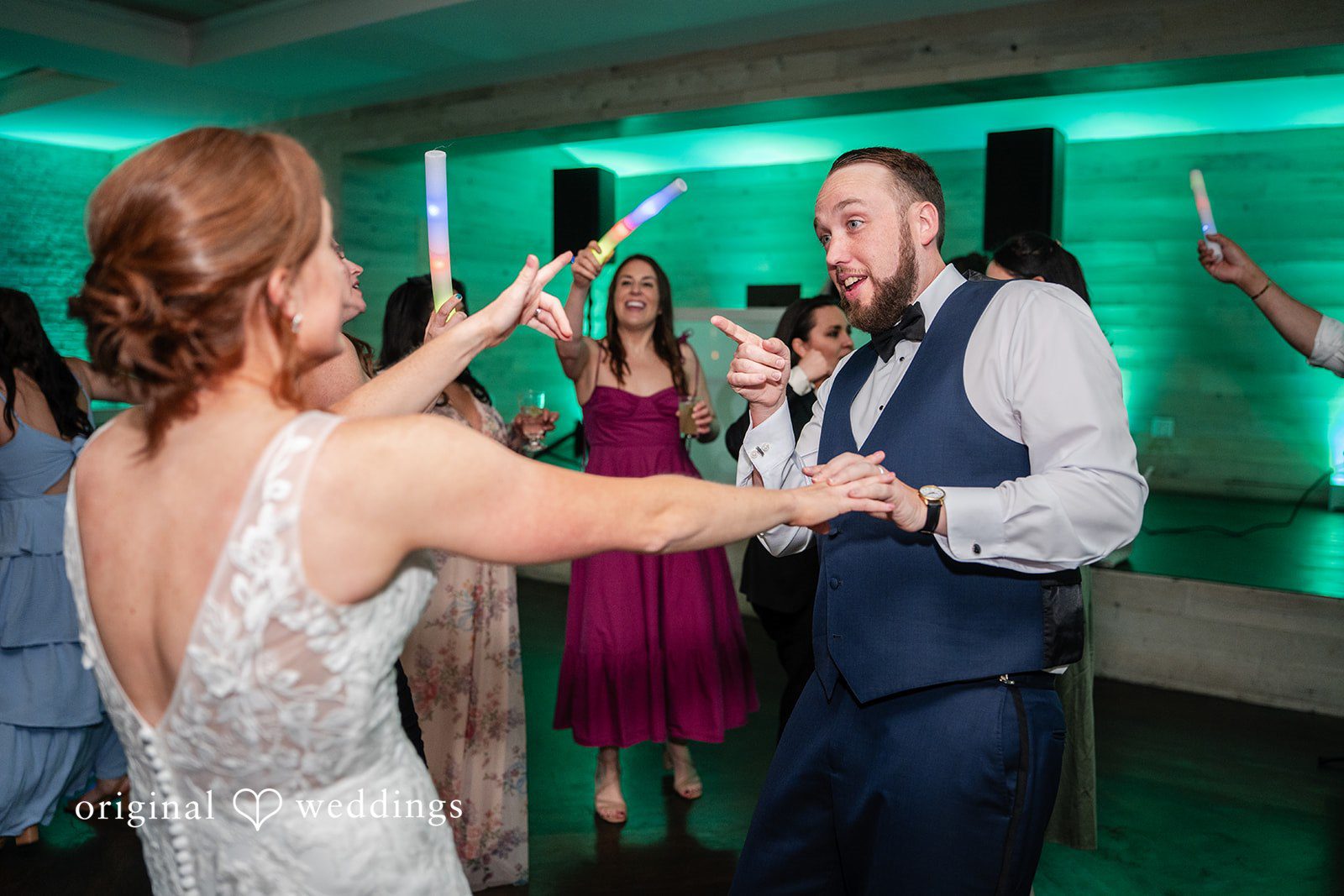 Bride and groom sharing joyful moments on the reception dance floor