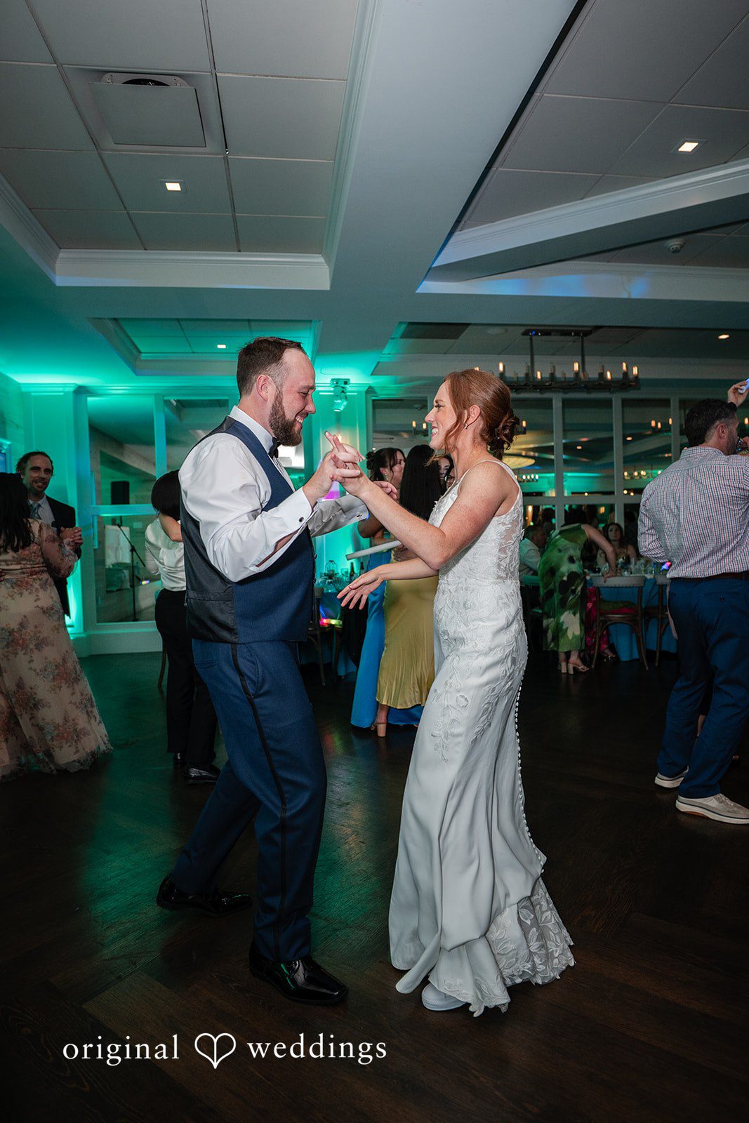 Newlyweds dancing with guests during the wedding celebration