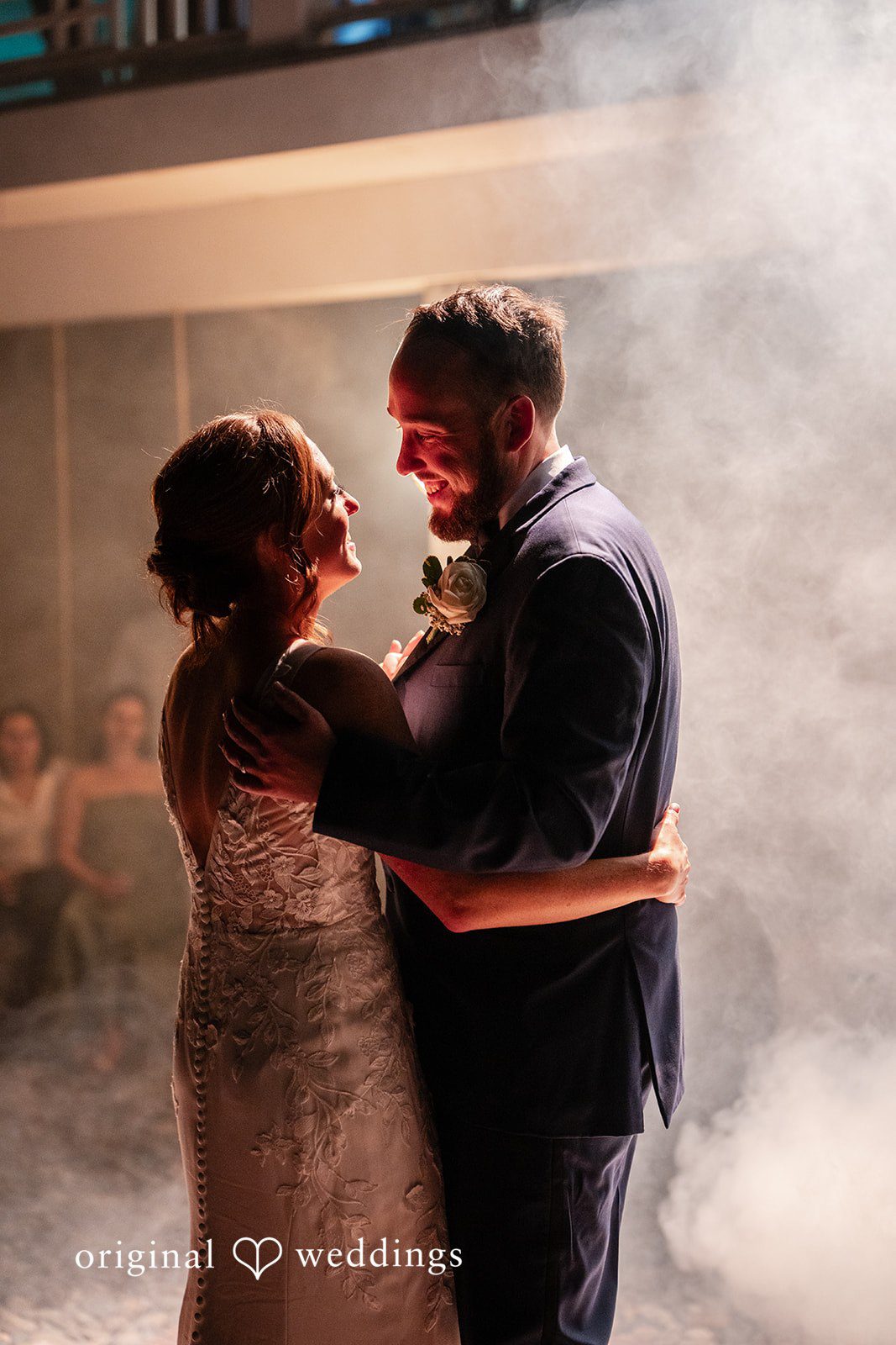 Bride and groom dancing together with their backs turned at the reception