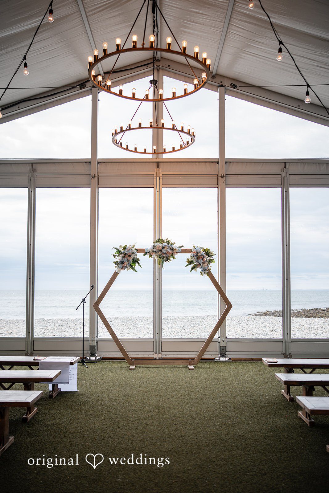 Empty ceremony space prepared for a waterfront wedding celebration