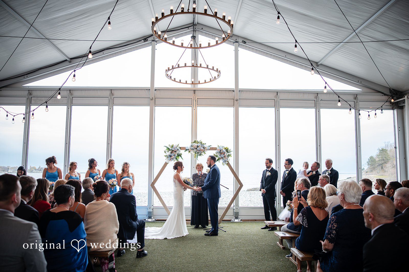 Bride and groom standing before guests during the ceremony