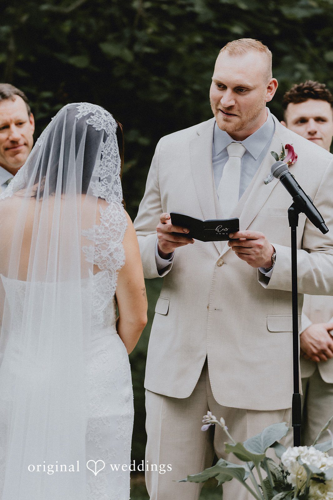 Groom reading his vows to the bride during wedding ceremony