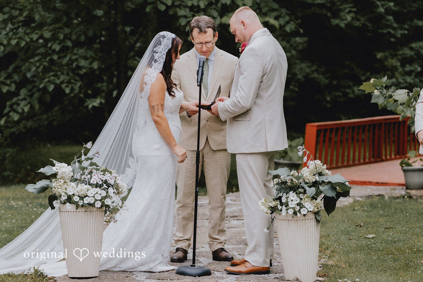 Bride and groom exchanging wedding rings during wedding ceremony