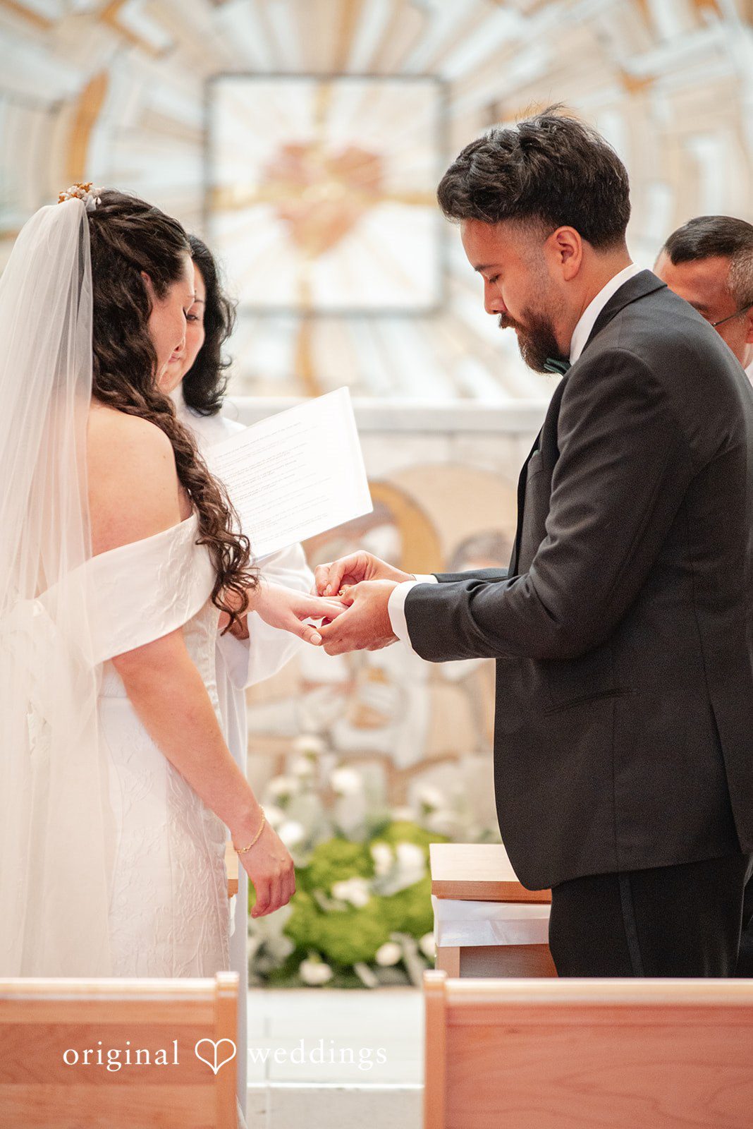 Paulina + Steve Groom placing a wedding ring on the bride’s finger