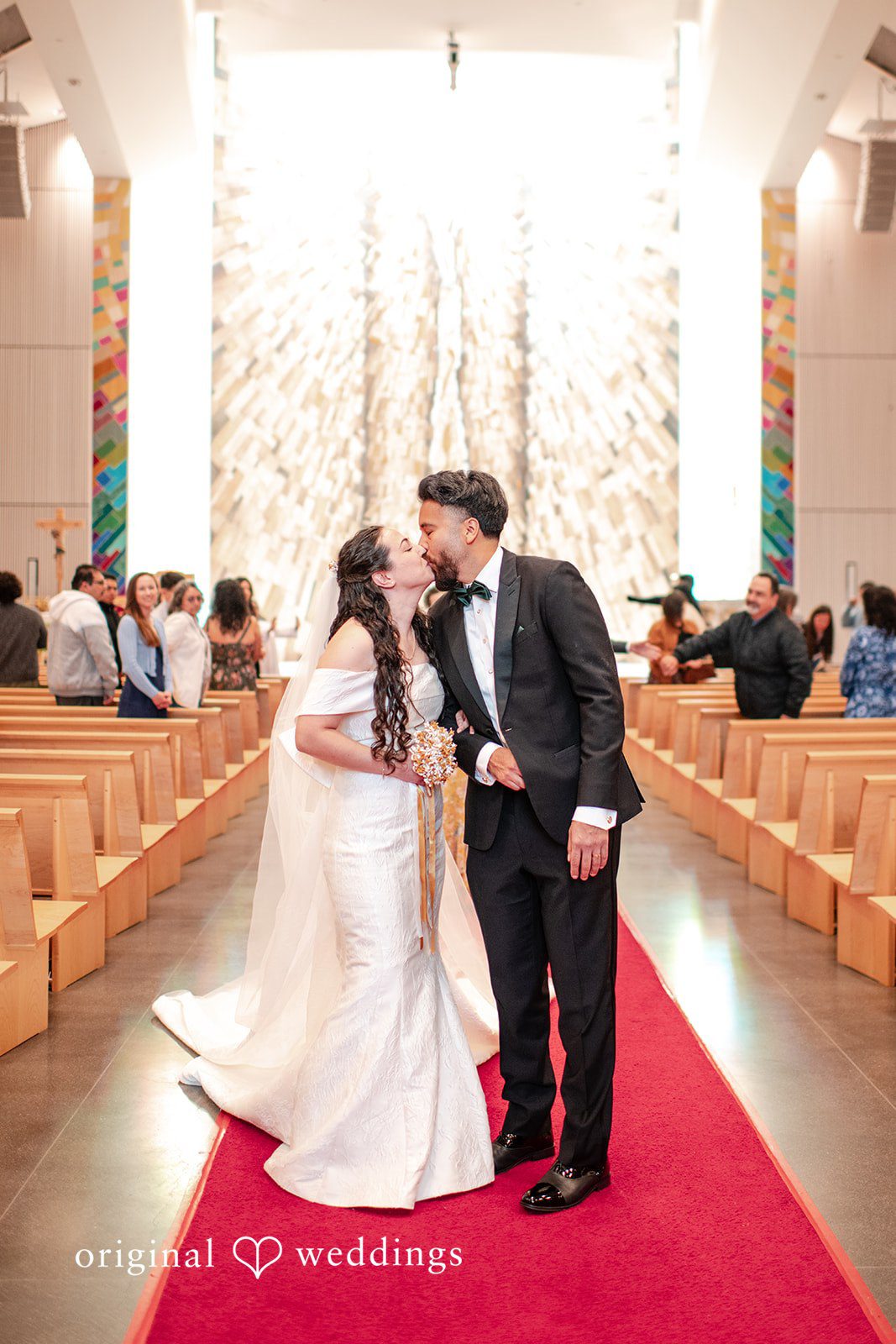 Paulina + Steve Bride and groom kissing together inside the ceremony venue