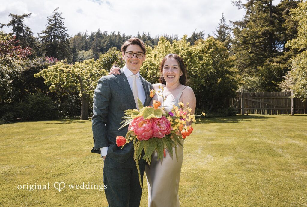 Benjamin + Amber The happy couple poses together with a vibrant bouquet captured by Seattle wedding photographers from Original Weddings