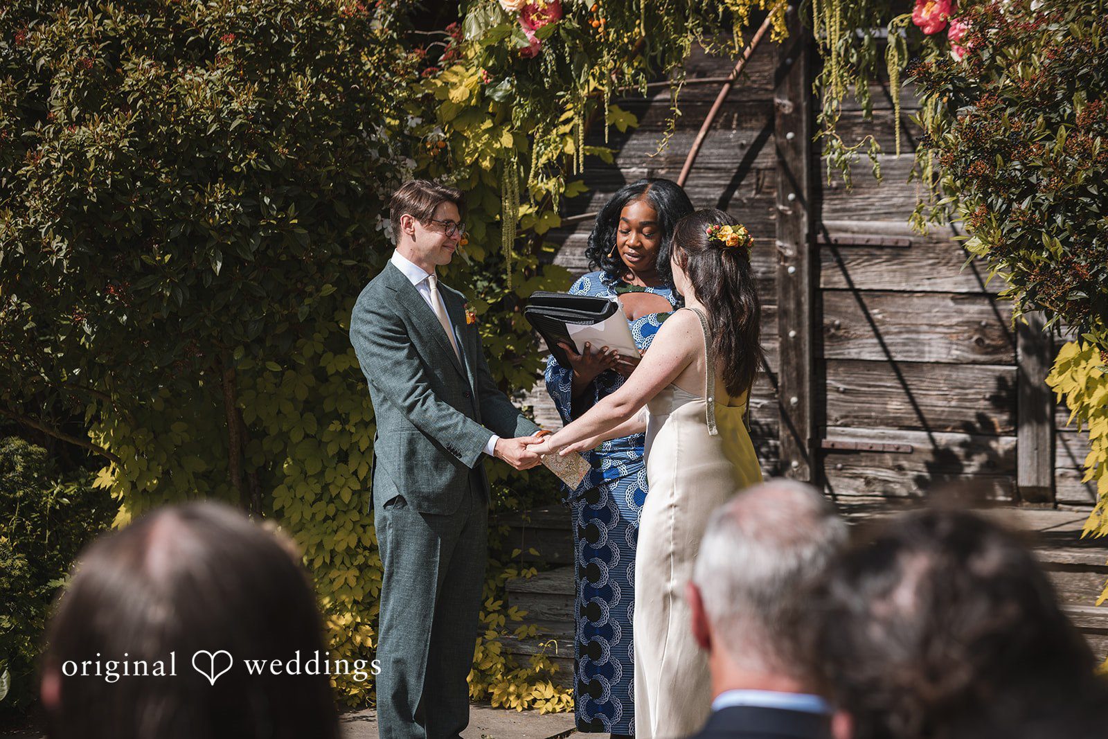 Benjamin + Amber The couple holds hands and shares a heartfelt moment during their intimate wedding ceremony at Outlook Inn.