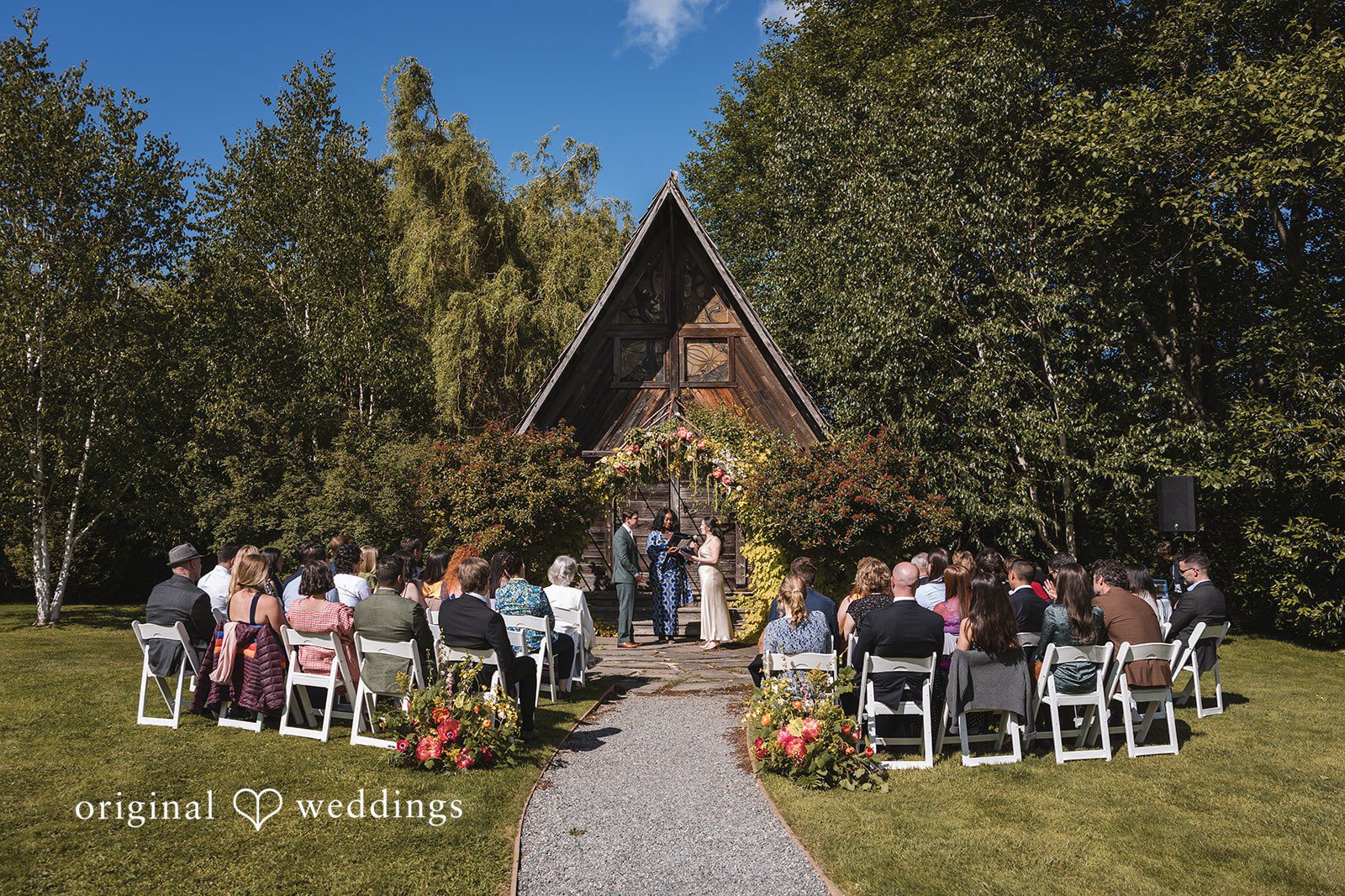 Benjamin + Amber Guests watch as the couple exchanges vows during a beautiful outdoor wedding ceremony