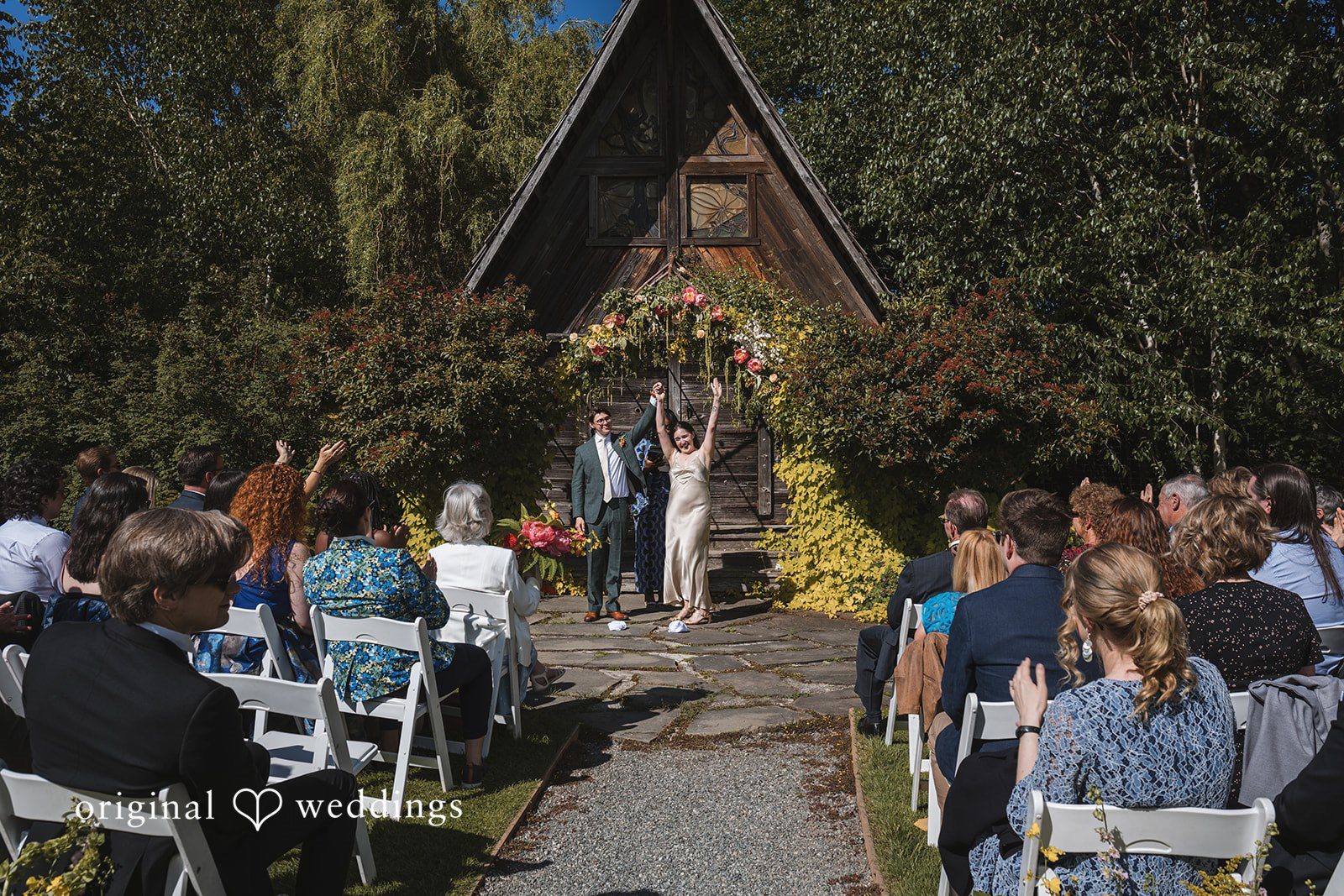 Benjamin + Amber The newlyweds celebrate their joyful recessional as guests cheer during their outdoor wedding ceremony at Outlook Inn.