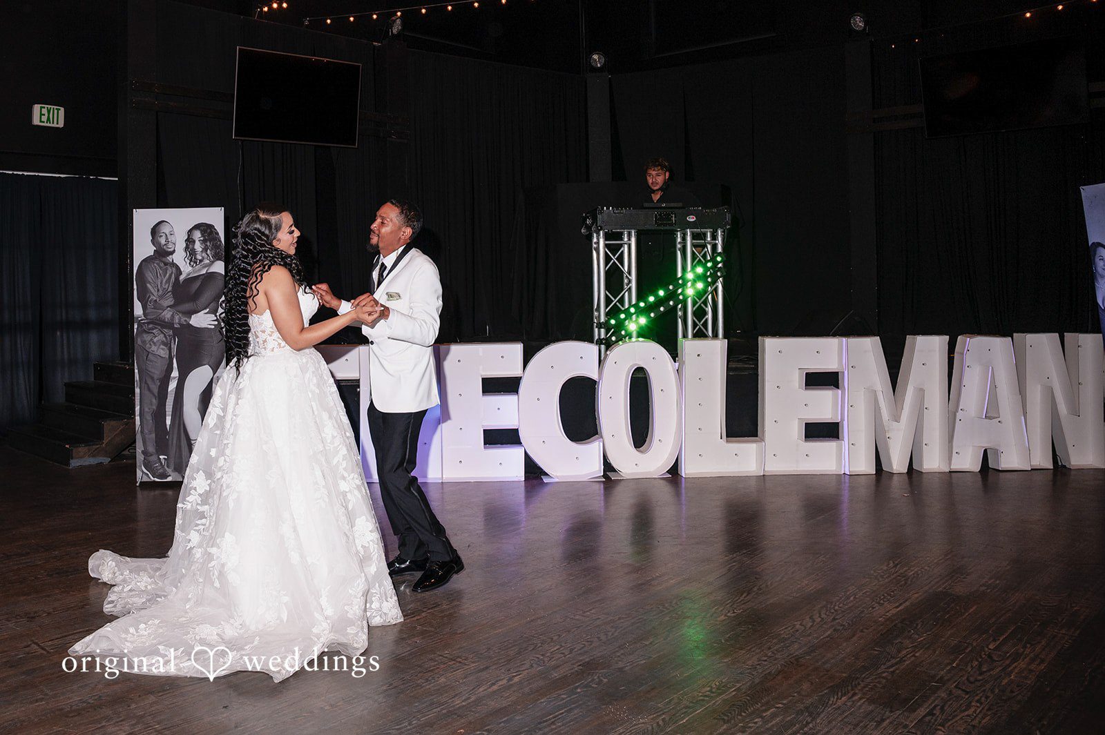 A bride and groom hold hands while dancing on a dark wooden floor at Radiance Event Center.
