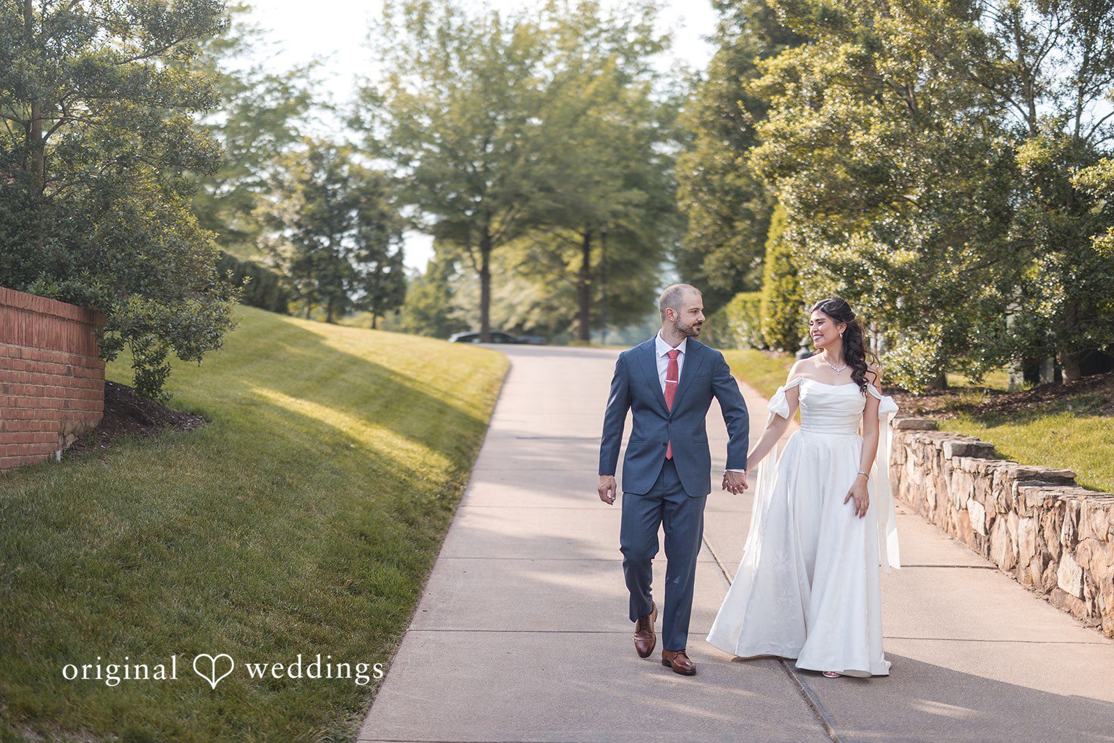 The couple takes a walk through the outdoors of the venue