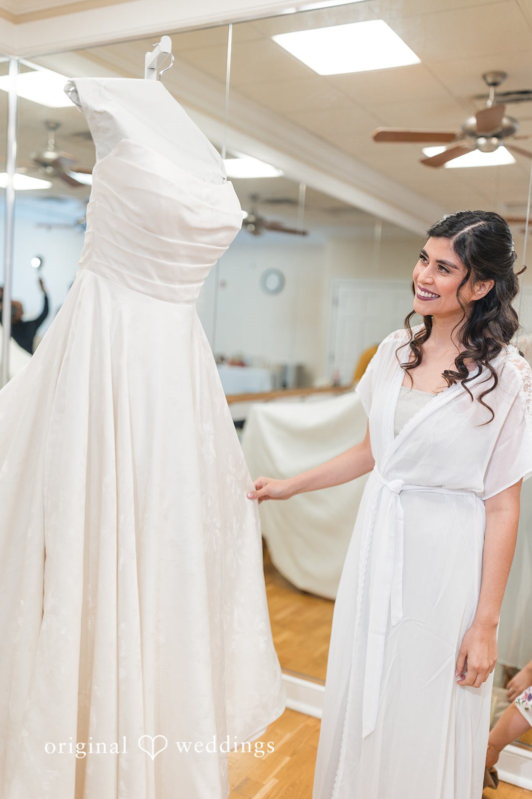 The bride checks out her wedding gown