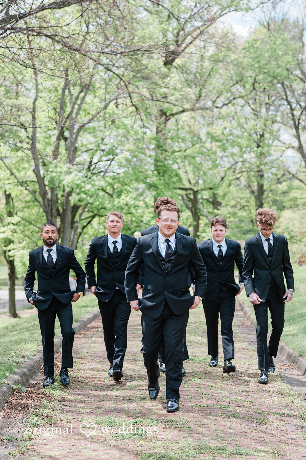 Groom walking with his groomsmen before the wedding ceremony