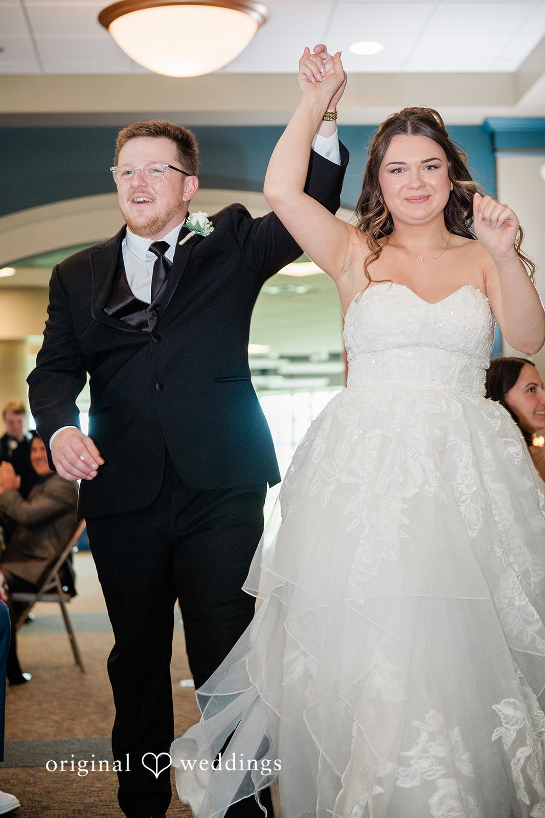 Couple listening as friends give speeches during the reception