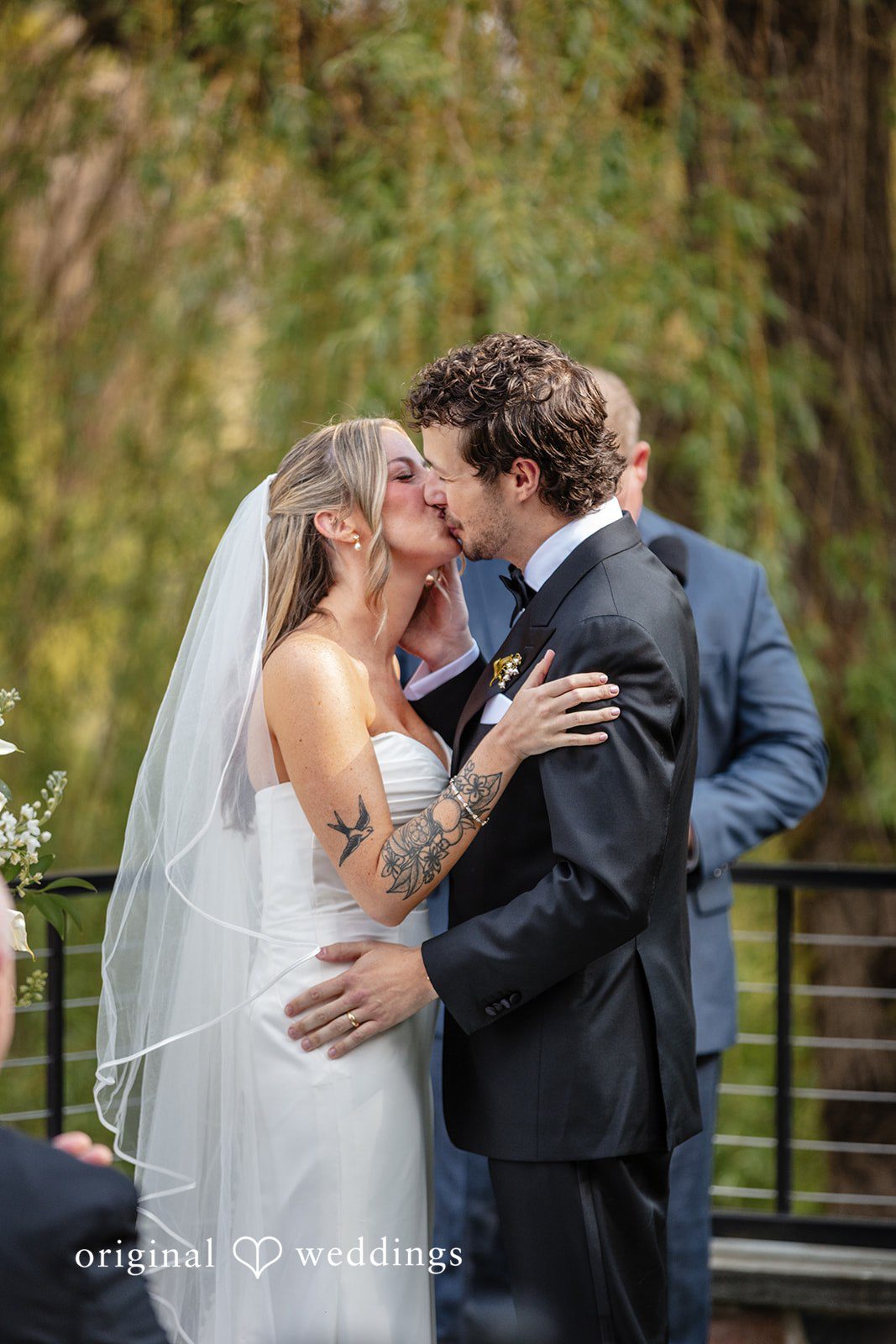 Bride and groom sharing their first kiss after the ceremony