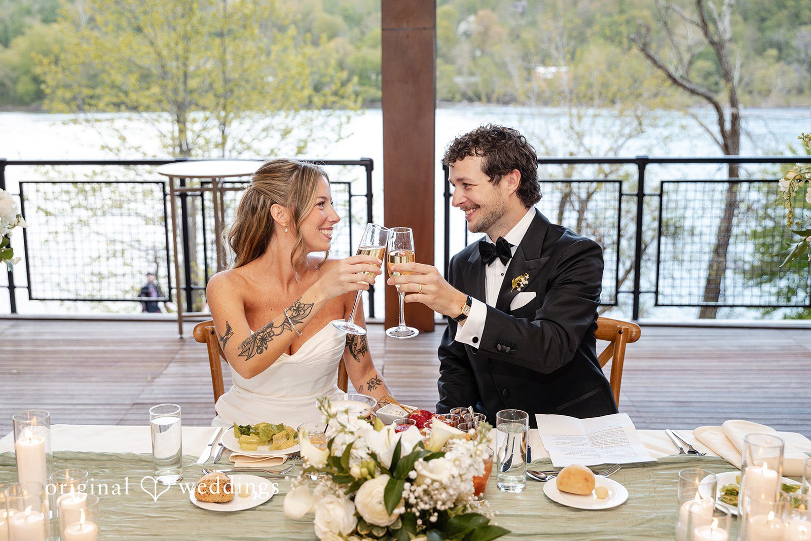 Bride and groom enjoying a meal at their reception table