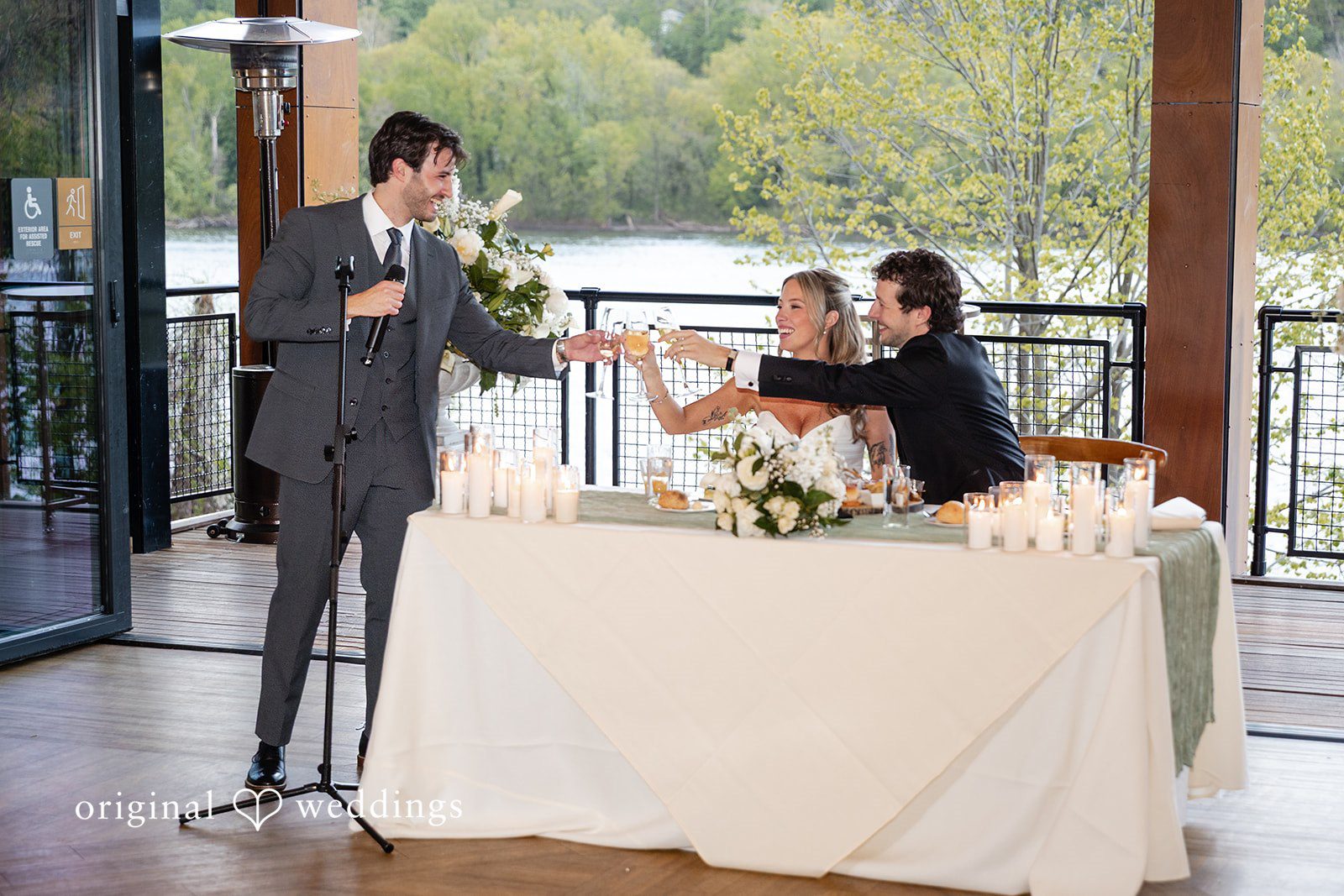 Bride and groom raising a toast during the reception