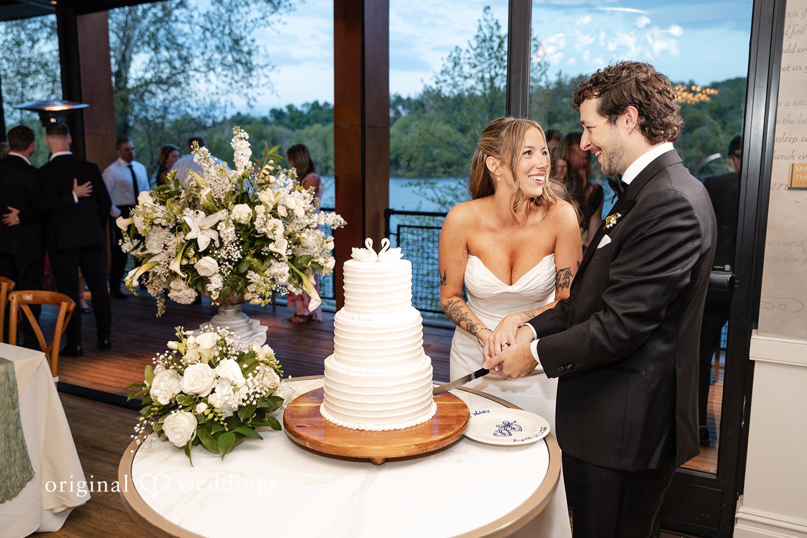 Bride and groom cutting their wedding cake together