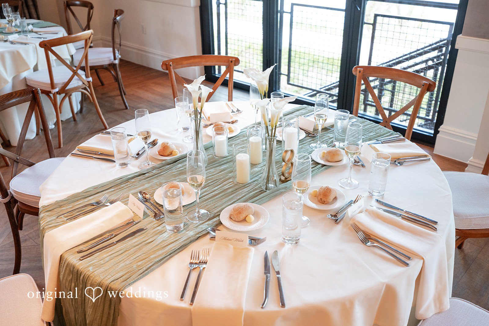 Close-up of reception table decor with floral arrangements and candles