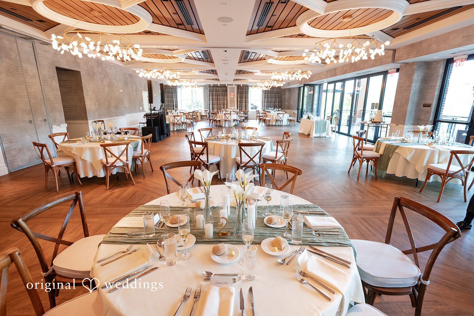 Wide view of decorated reception tables before guests arrive