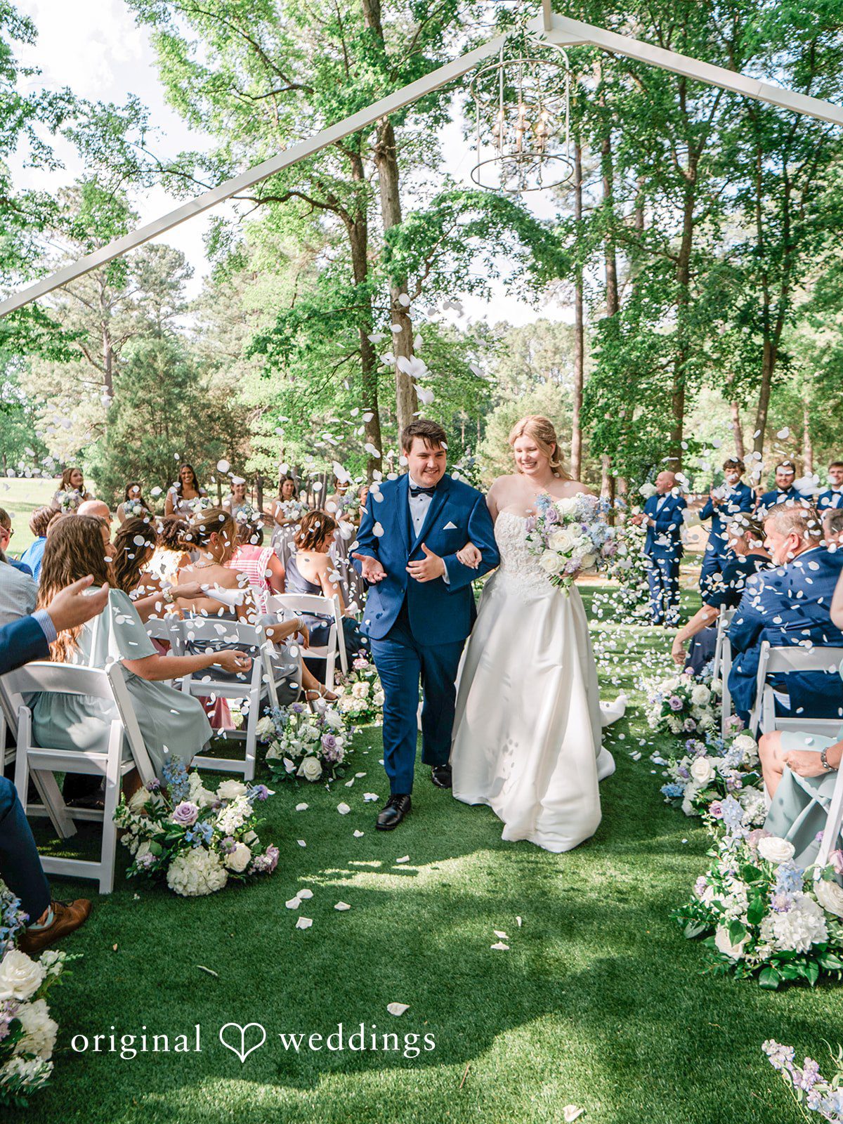 Our Raleigh wedding photographers captured the moment the couple made a grand exit with cheers from guests