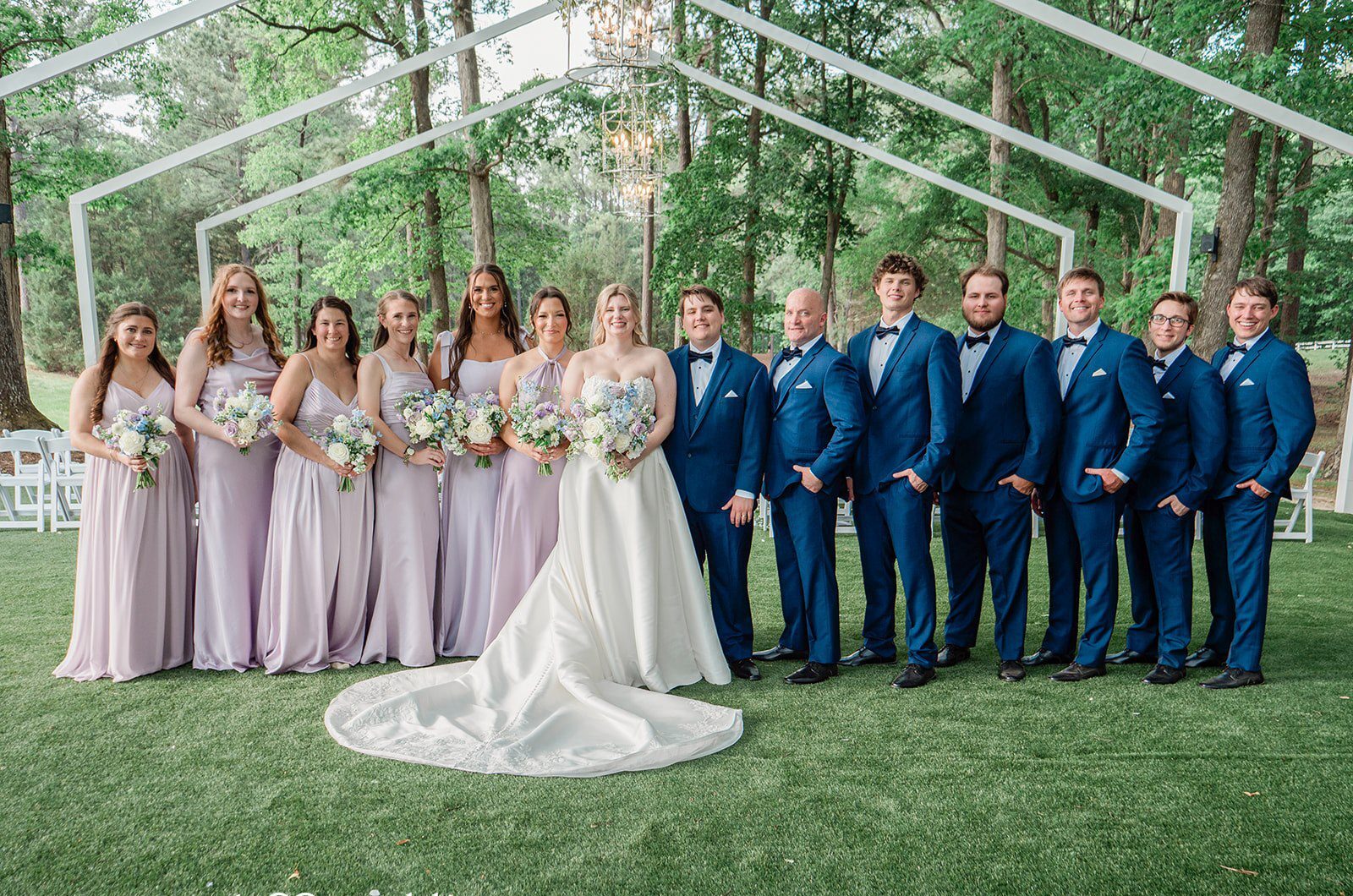 Our Raleigh wedding photographers at Original Weddings captured a stunning portrait of the couple and their bridal party at Seven Paths Manor