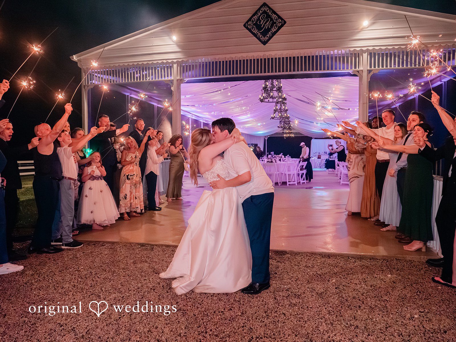 The couple makes a romantic exit with cheers from guests