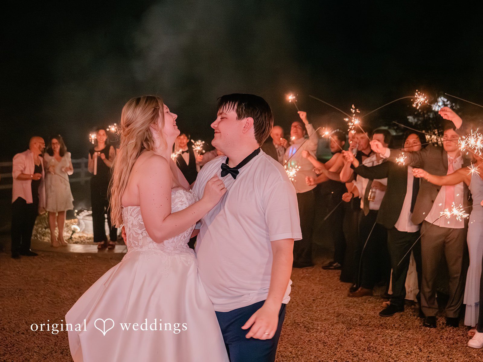 Guests cheer the couple with sparklers
