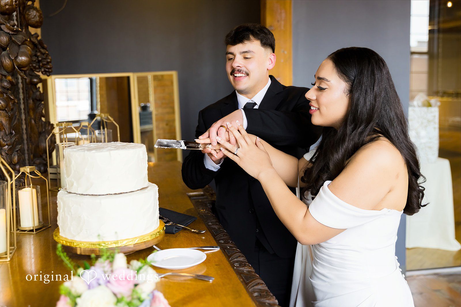Kiarra + Anthony Minneapolis Wedding Photographers capturing the couple cutting the cake at Solar Arts by Original Weddings