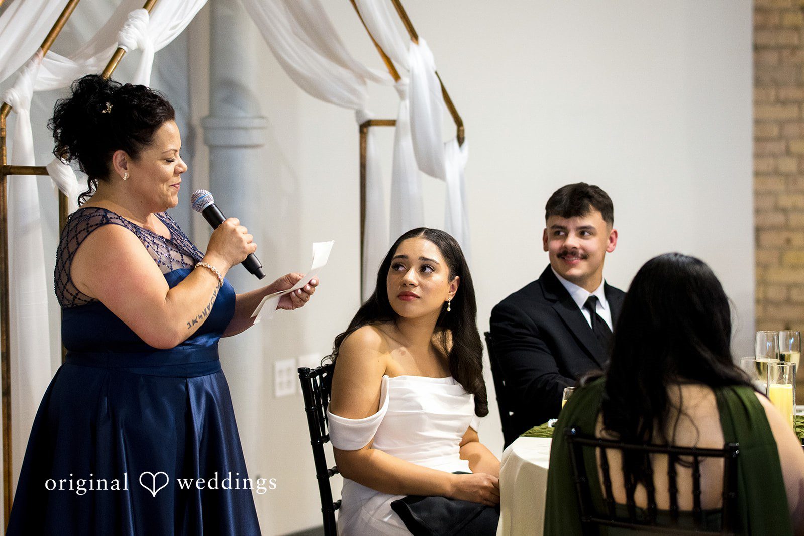 Kiarra + Anthony Elegant bride and groom seated together at Solar Arts