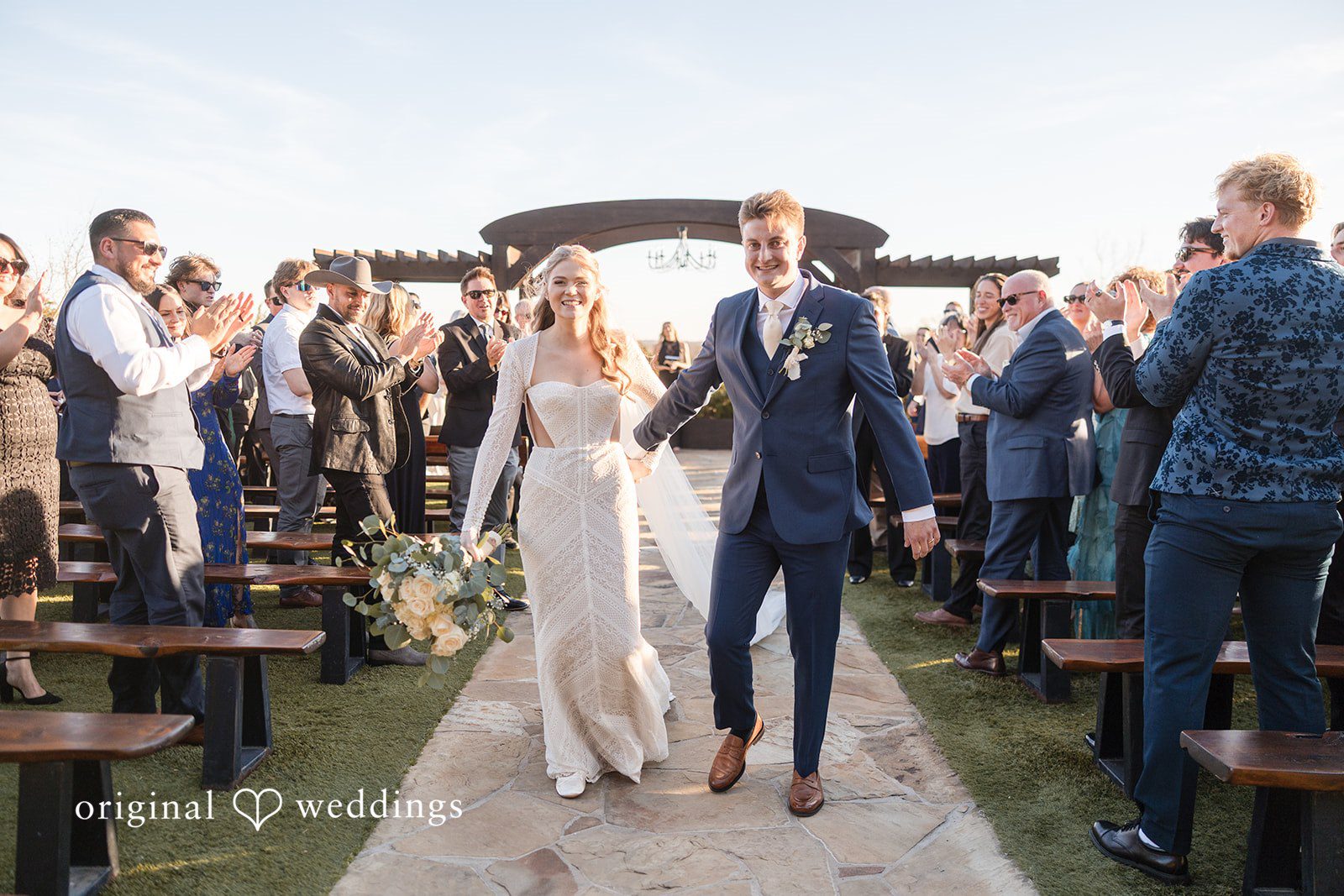 Jacobi + Marlie Dallas Wedding Photographers capturing couple walking out of ceremony while smiling at Stone Crest by Original Weddings