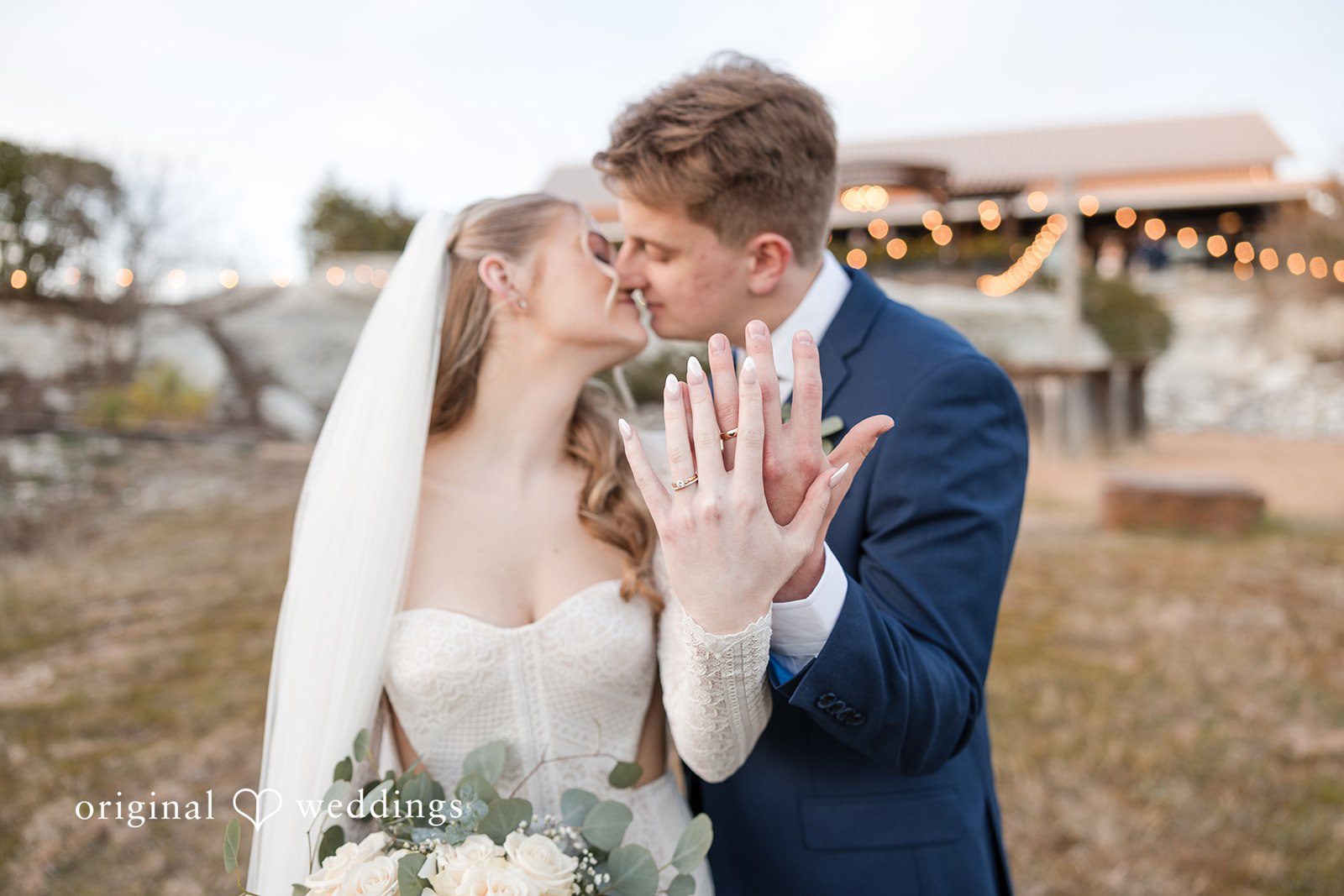 Jacobi + Marlie Dallas Wedding Photographers capturing couple kissing and showing wedding rings at Stone Crest by Original Weddings