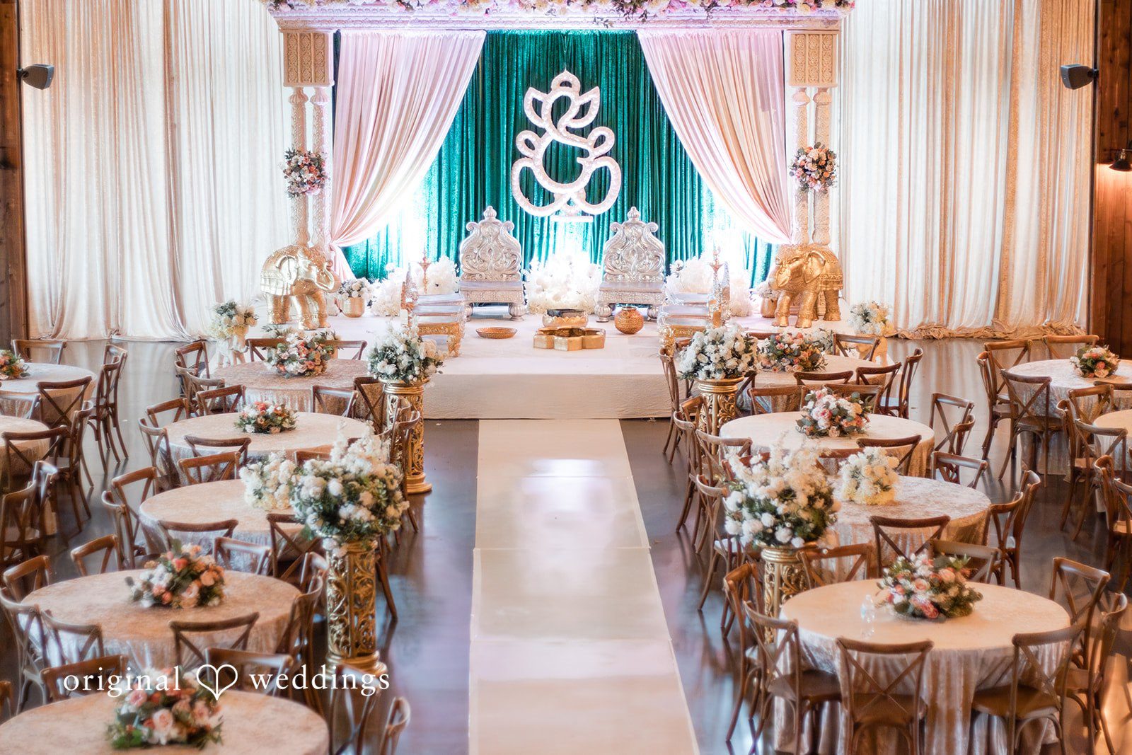 A wedding venue aisle lined with decorated banquet tables at Stone Crest.