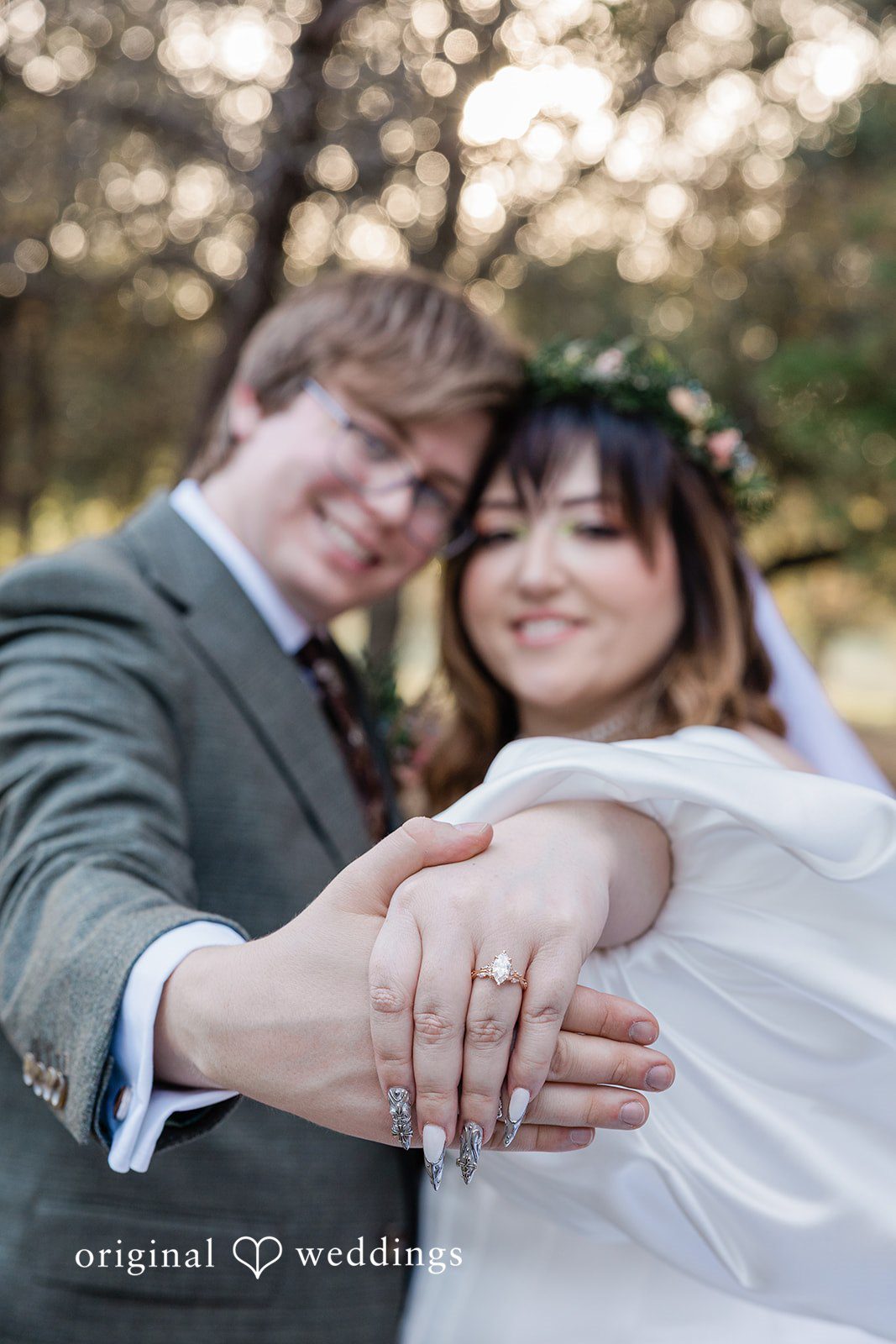Brittney + Benjamin Close-up of a smiling bride and groom showing off the wedding ring.