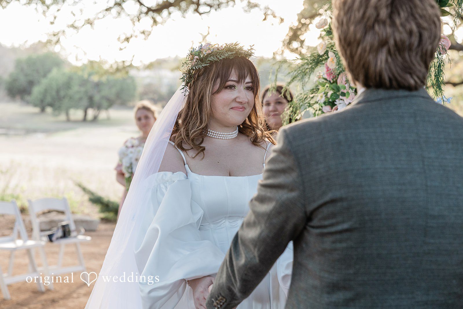 November 15, 2025 – Brittney & Benjamin- (ID-3986) Close-up of a bride in a white gown and veil looking toward her groom.