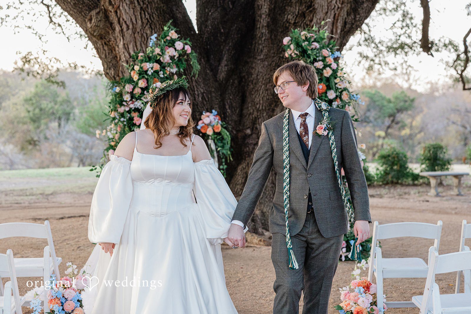 Brittney + Benjamin A bride and groom holding hands and walking together after their ceremony.