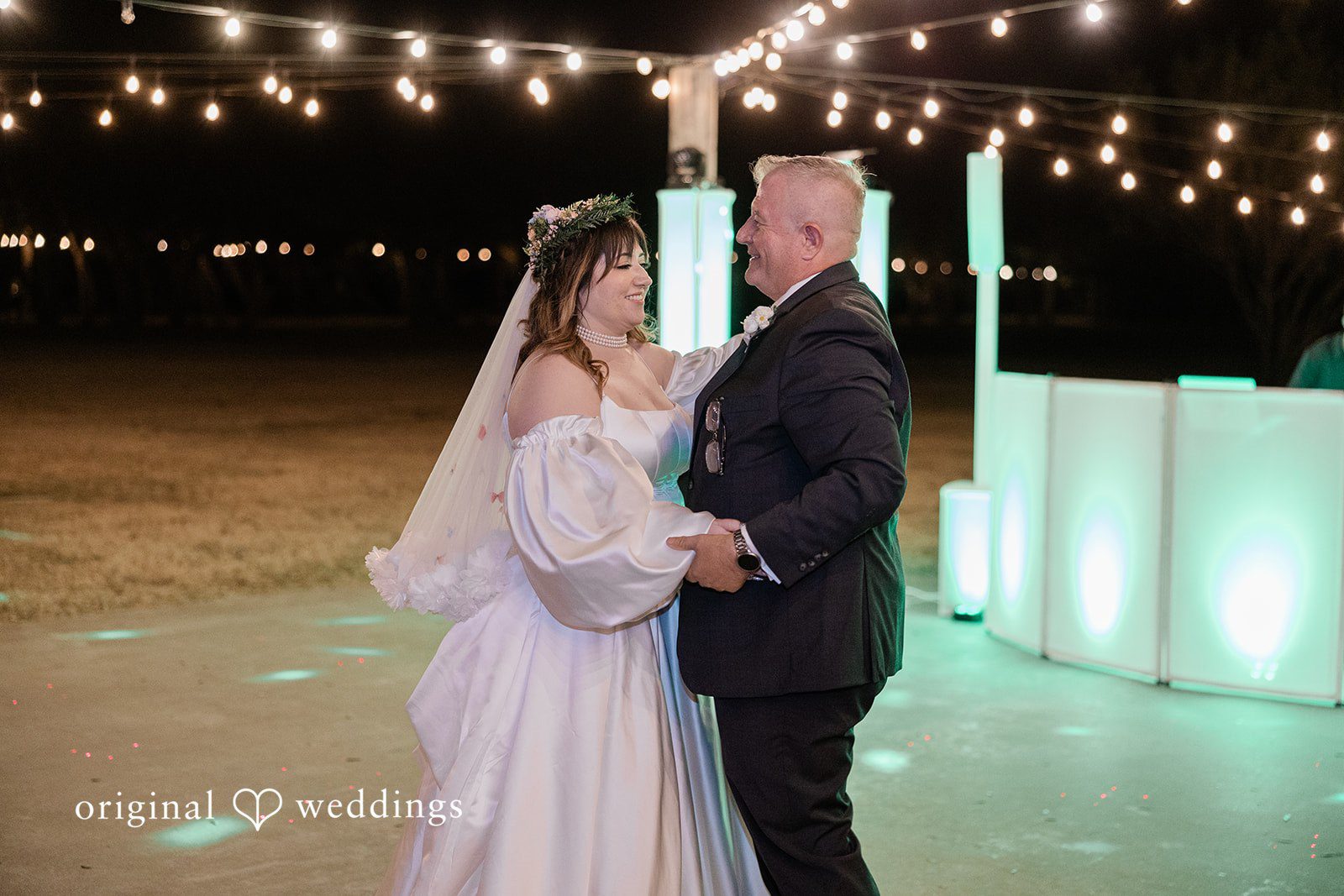 Brittney + Benjamin A bride and man dancing at an illuminated reception venue.