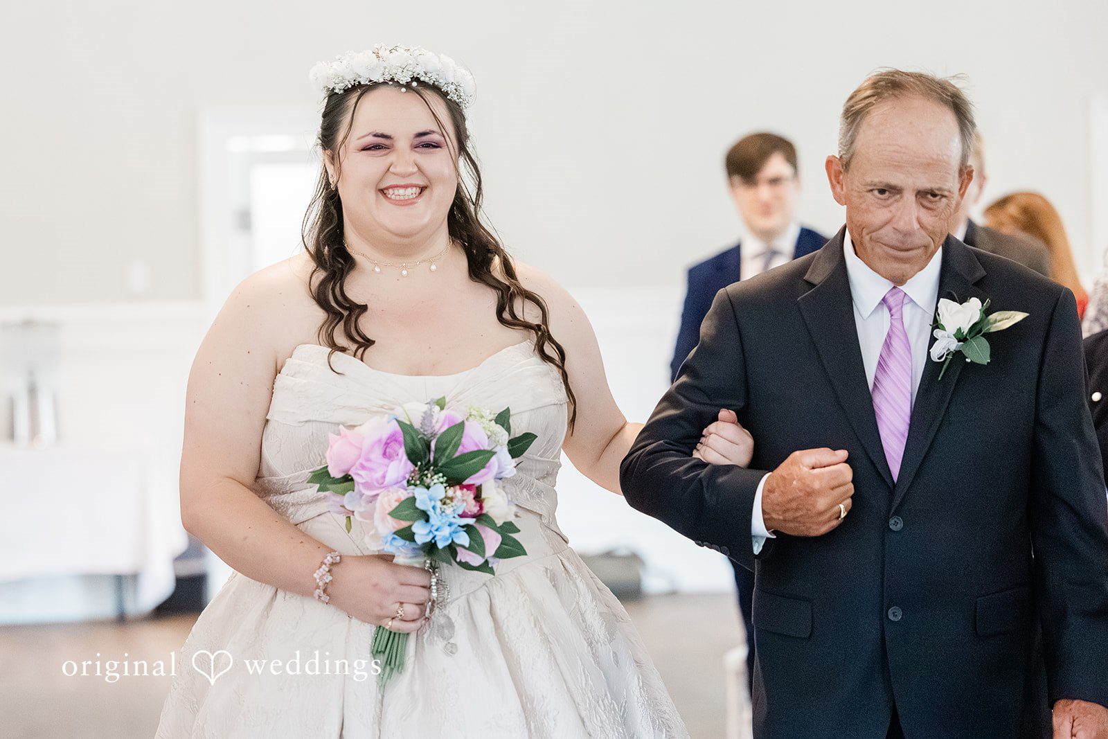 Beautiful bride walking down the aisle arms in arms with someone