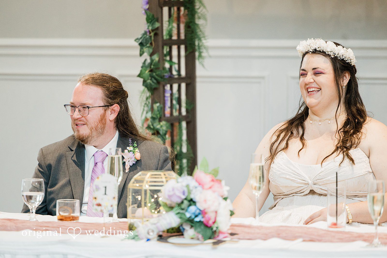Beautiful couple seated at wedding reception table