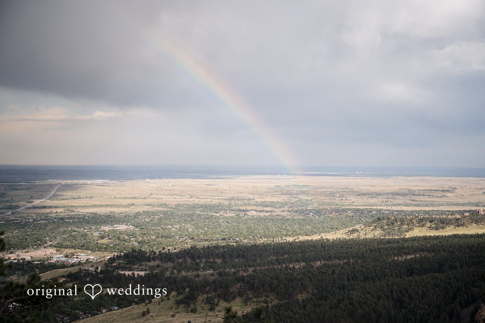 Jacquelyn + Millard Rainbow over the mountain landscape at Sunrise Amphitheater before the wedding ceremony.